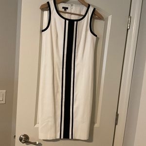 white sleeveless dress with black piping and black center strip